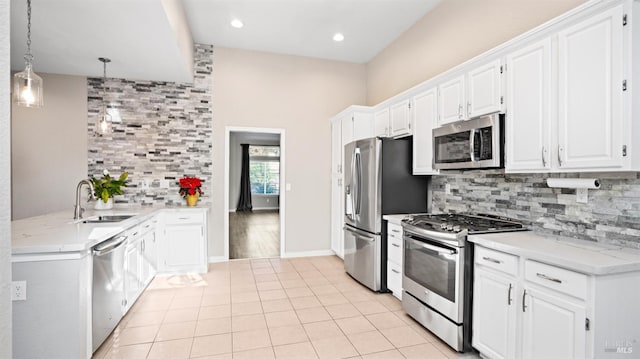 kitchen featuring pendant lighting, white cabinetry, and stainless steel appliances