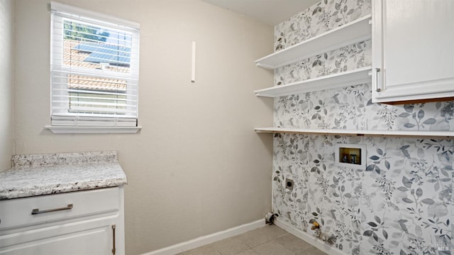 laundry room with a healthy amount of sunlight, cabinet space, light tile patterned floors, and hookup for a washing machine