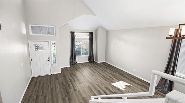 entryway featuring baseboards, wood finished floors, and vaulted ceiling