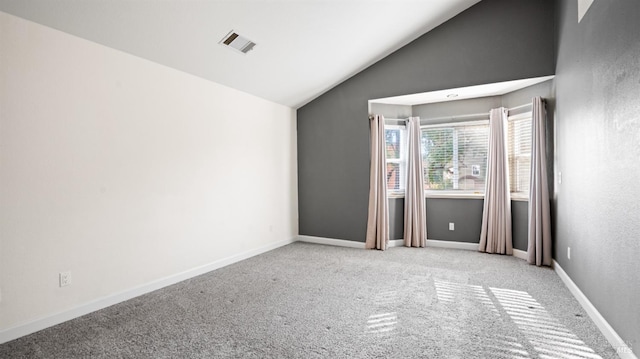 unfurnished room featuring light carpet and lofted ceiling