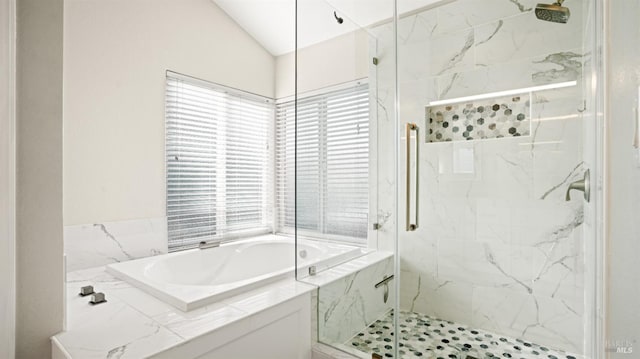 bathroom featuring separate shower and tub, vaulted ceiling, and plenty of natural light