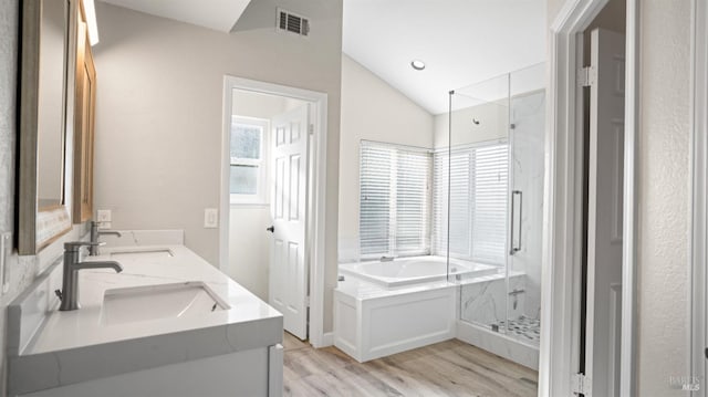 bathroom with vanity, wood-type flooring, lofted ceiling, and shower with separate bathtub