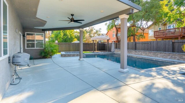 view of pool featuring a fenced backyard, a ceiling fan, a fenced in pool, and a patio area