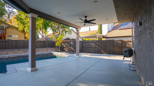 view of pool with ceiling fan and a patio area