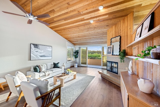 living room featuring hardwood / wood-style flooring, vaulted ceiling, ceiling fan, and wood ceiling