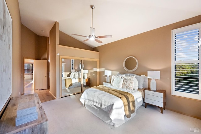 bedroom featuring light carpet, a closet, high vaulted ceiling, and ceiling fan