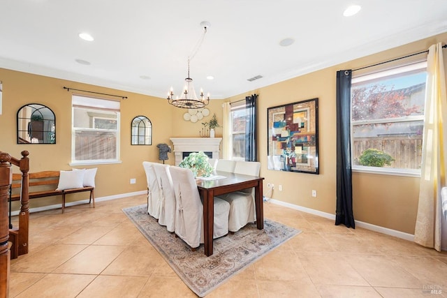 dining space with plenty of natural light, light tile patterned floors, and a chandelier