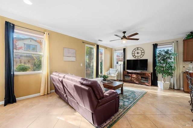 living room featuring light tile patterned floors, a wealth of natural light, and ornamental molding