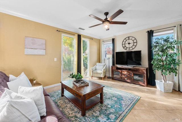 living room with ceiling fan, ornamental molding, and light tile patterned floors