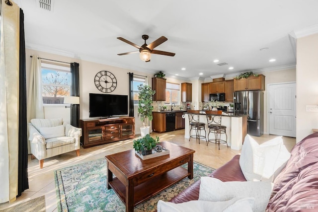 tiled living room with ornamental molding, sink, a wealth of natural light, and ceiling fan