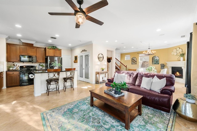 living room with light tile patterned floors, crown molding, and ceiling fan with notable chandelier