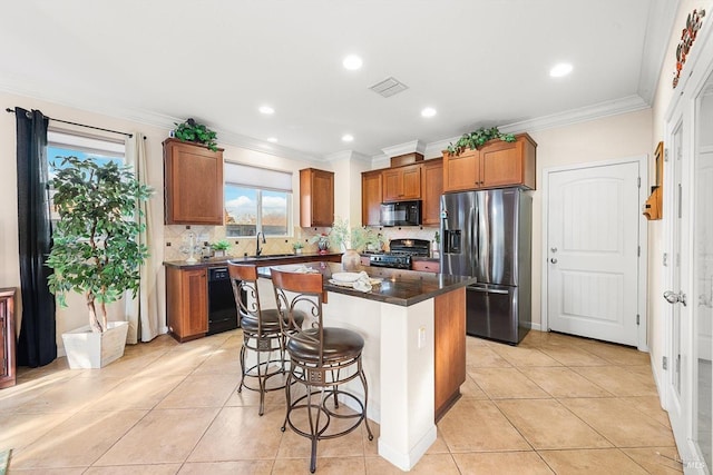 kitchen with a kitchen island, a breakfast bar, ornamental molding, light tile patterned floors, and black appliances