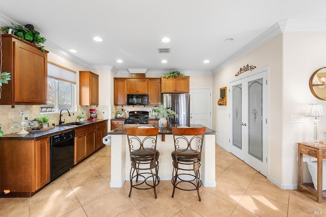 kitchen with sink, tasteful backsplash, crown molding, a kitchen island, and black appliances