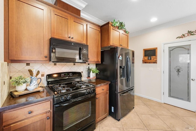 kitchen featuring light tile patterned floors, decorative backsplash, ornamental molding, and black appliances