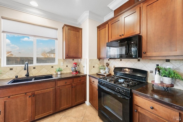 kitchen featuring sink, crown molding, tasteful backsplash, black appliances, and light tile patterned flooring