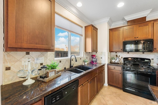 kitchen featuring sink, dark stone countertops, light tile patterned floors, ornamental molding, and black appliances