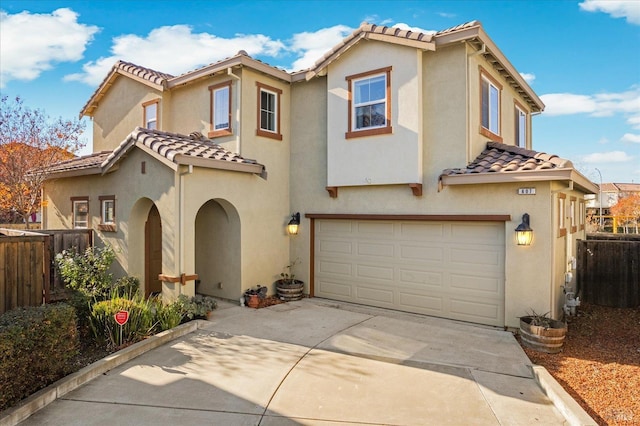 mediterranean / spanish house featuring a garage