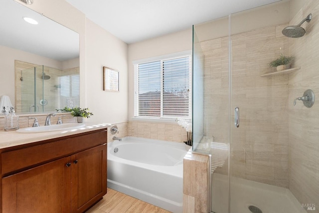 bathroom with independent shower and bath and vanity