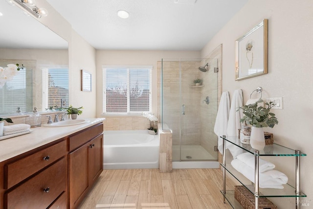 bathroom featuring vanity, hardwood / wood-style flooring, and independent shower and bath