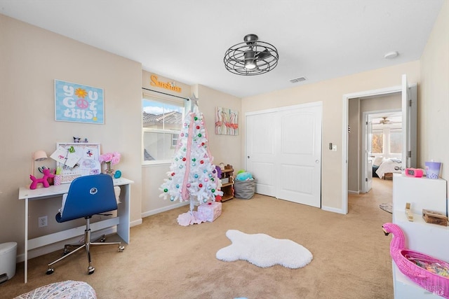 bedroom featuring light carpet and a closet