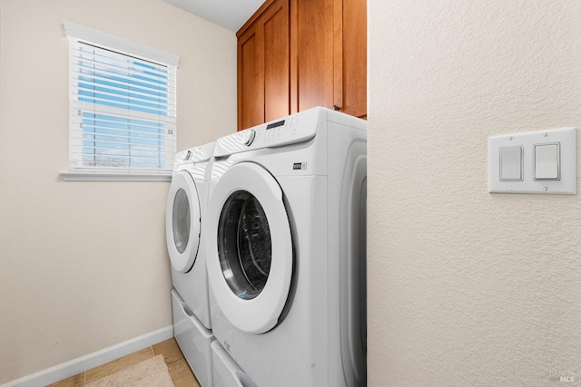 washroom featuring cabinets, light tile patterned flooring, and independent washer and dryer