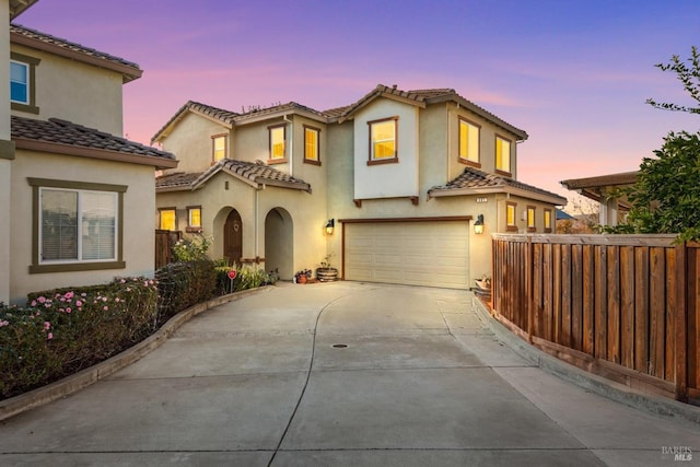 mediterranean / spanish house with a garage