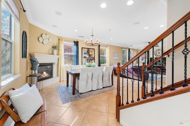 tiled living room with ornamental molding and a notable chandelier