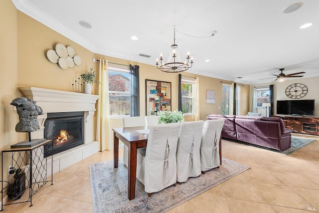 tiled dining space featuring ornamental molding and ceiling fan with notable chandelier