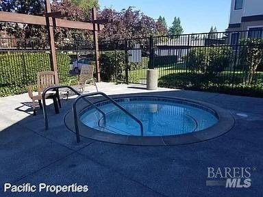 view of swimming pool with an in ground hot tub and a patio area