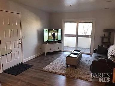 living room featuring dark hardwood / wood-style flooring