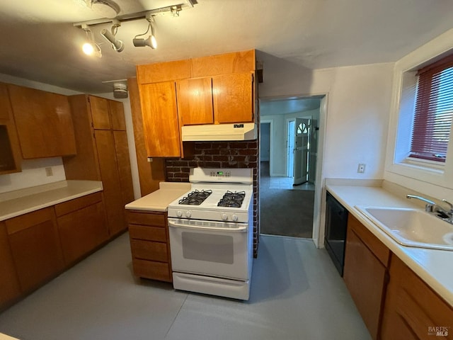 kitchen featuring white gas stove, brown cabinetry, a sink, and under cabinet range hood