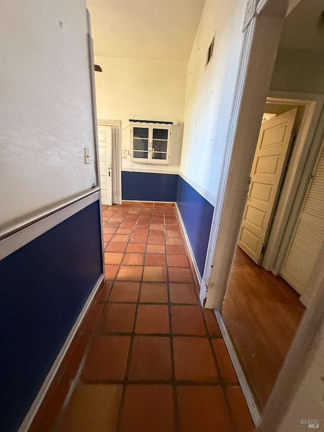 corridor featuring tile patterned flooring and visible vents