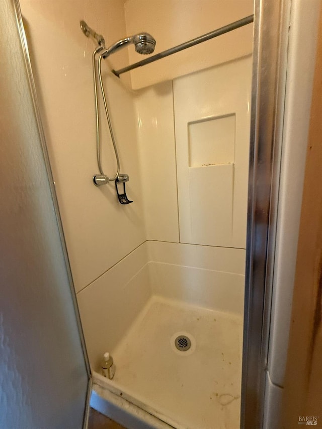 full bath with a shower stall