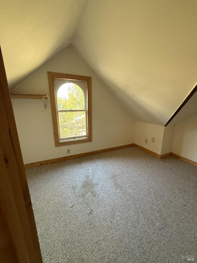 bonus room with carpet, lofted ceiling, and baseboards