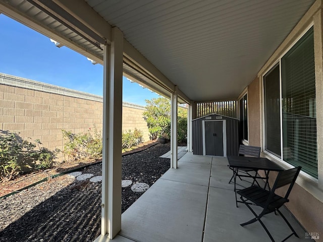 view of patio / terrace featuring a storage shed