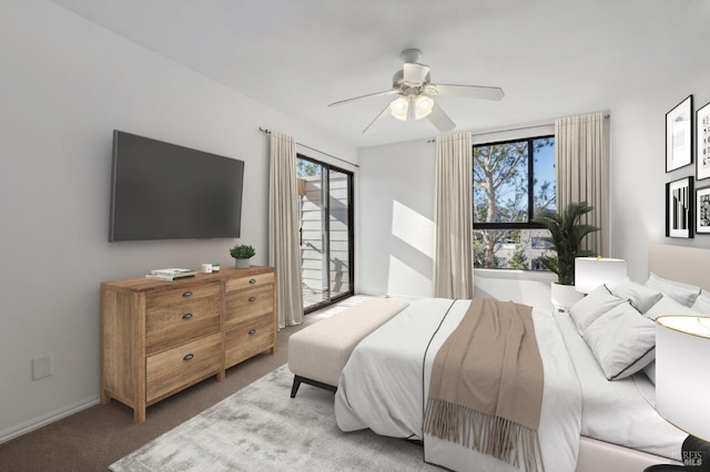 carpeted bedroom with ceiling fan and multiple windows