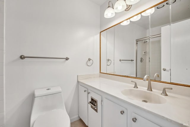 bathroom featuring vanity, toilet, and a shower with door