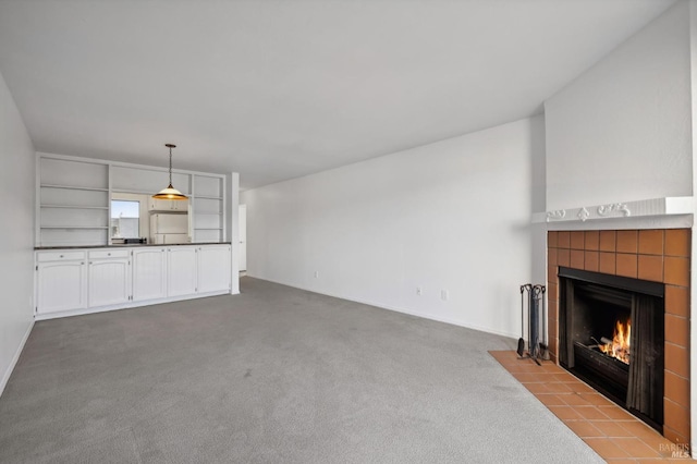 unfurnished living room featuring a fireplace and light colored carpet