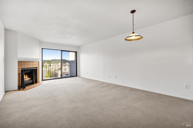 unfurnished living room with a fireplace and carpet