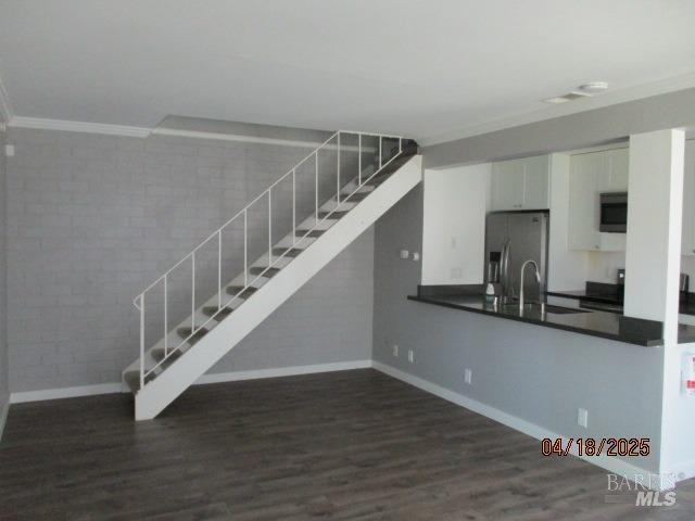46 Tahoe Cir, Novato, CA 94947 - interior space featuring crown molding, baseboards, wood finished floors, and brick wall