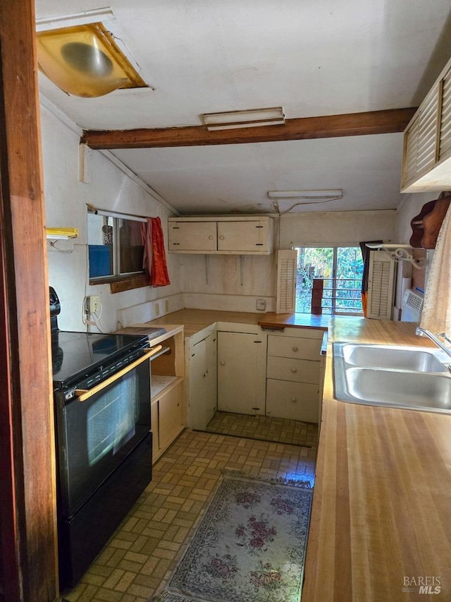 kitchen with vaulted ceiling with beams, brick floor, butcher block counters, a sink, and black electric range oven