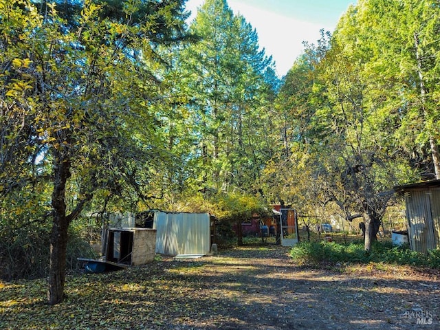 view of yard with an outdoor structure and fence