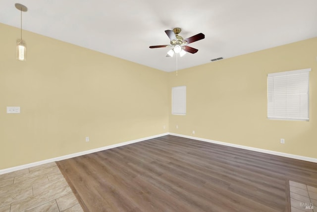 spare room with ceiling fan and wood-type flooring