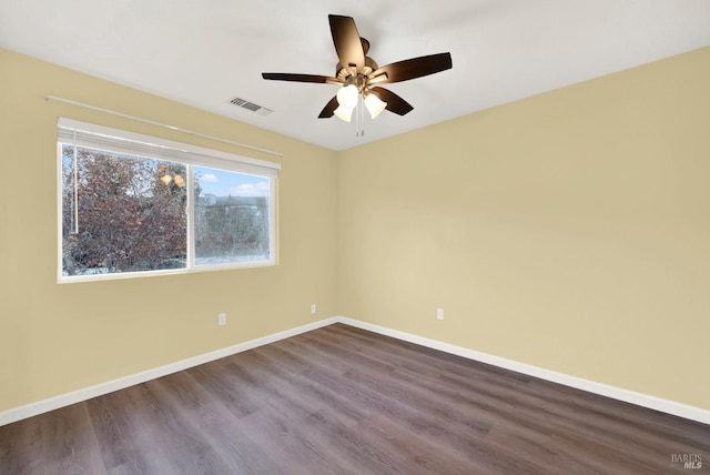 empty room with hardwood / wood-style floors and ceiling fan