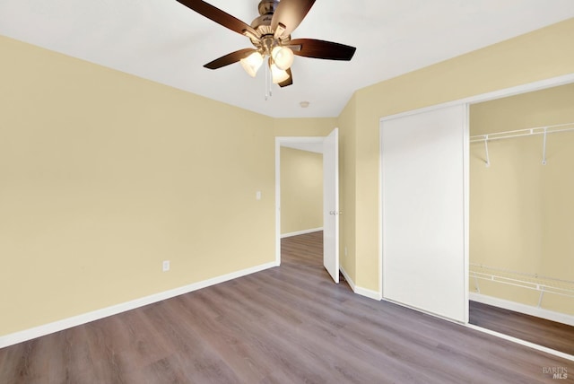 unfurnished bedroom with hardwood / wood-style floors, ceiling fan, and a closet