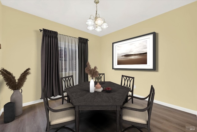 dining area featuring a notable chandelier and dark wood-type flooring