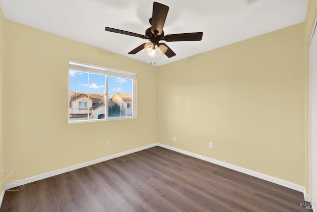 spare room with ceiling fan and wood-type flooring