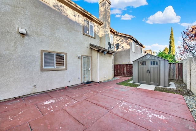 rear view of house featuring a shed and a patio