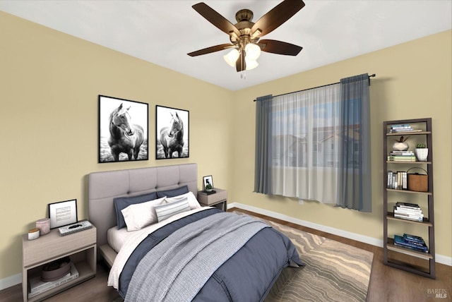 bedroom with ceiling fan and dark hardwood / wood-style floors