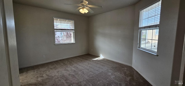 carpeted spare room featuring ceiling fan